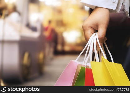 Shopaholic woman with shopping bags, buying a lot of fashion clothes.