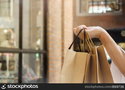 Shopaholic woman with shopping bags, buying a lot of fashion clothes