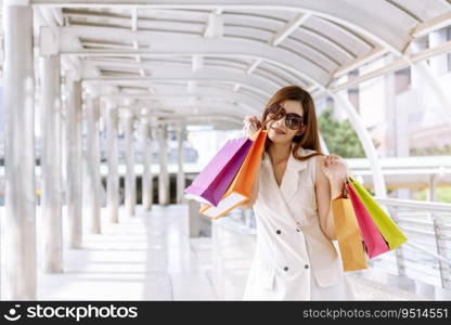 Shopaholic Women holding shopping bags ,money ,credit card person at shopping malls.Fashionable Woman love online website with sales tag on black Friday. E-commerce fashion digital marketing lifestyle