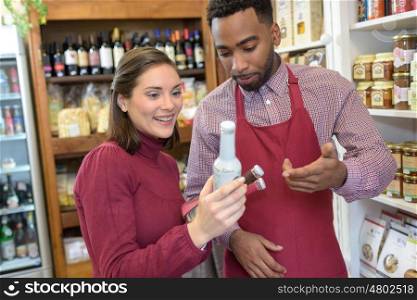 Shopkeeper advising customer