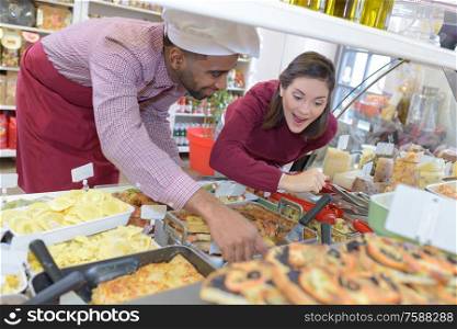 shopkeeper gives pastry to woman