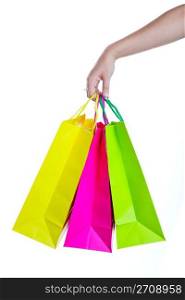 Shopper holding shopping bags, in bright spring colors. Shot on white background.