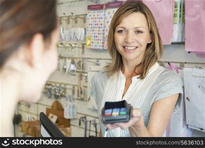Shopper Paying For Goods Using Credit Card Machine