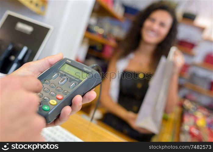 shopper typing code into credit card machine