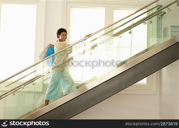 Shopper Walking up Stairs with Shopping Bags