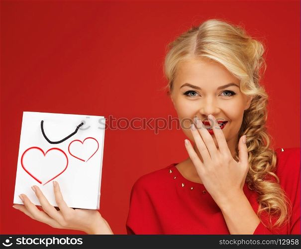 shopping and love concept - lovely woman in red dress with shopping bag