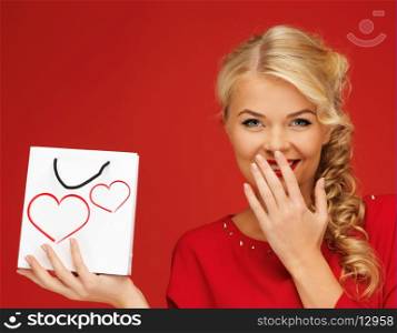 shopping and love concept - lovely woman in red dress with shopping bag