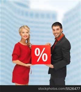 shopping and sale concept - smiling man and woman with percent sign outdoors