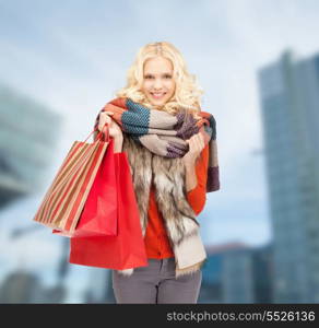 shopping and sale concept - smiling teenage girl with shopping bags outdoors