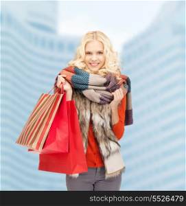 shopping and sale concept - smiling teenage girl with shopping bags outdoors