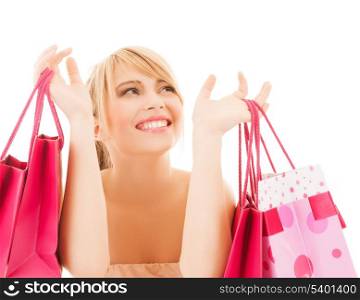 shopping and sales concept - happy woman with many shopping bags