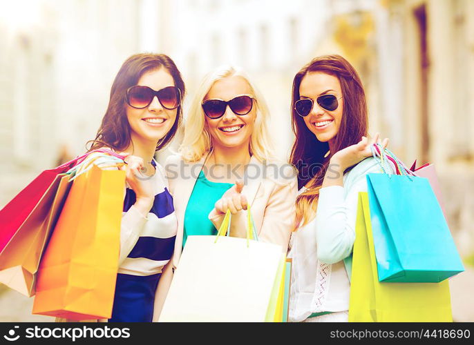 shopping and tourism concept - beautiful girls with shopping bags in ctiy. girls with shopping bags in ctiy