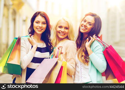 shopping and tourism concept - beautiful girls with shopping bags in ctiy. girls with shopping bags in ctiy