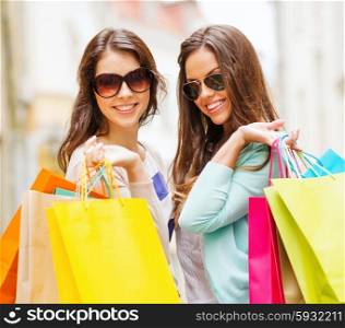 shopping and tourism concept - beautiful girls with shopping bags in ctiy. girls with shopping bags in ctiy
