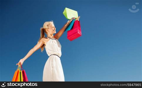 shopping and tourism concept - woman with shopping bags. woman with shopping bags