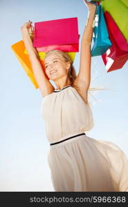 shopping and tourism concept - woman with shopping bags. woman with shopping bags