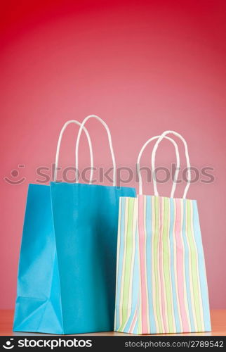 Shopping bags against gradient background