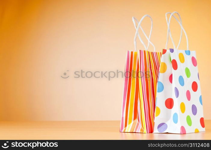 Shopping bags against gradient background