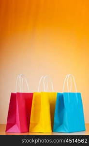 Shopping bags against gradient background