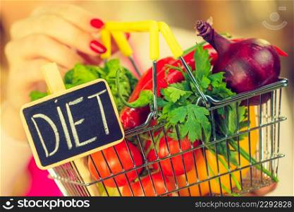 Shopping basket with diet sign and many colorful vegetables. Healthy eating lifestyle, vegetarian food.. Shopping backet with dieting vegetables