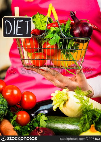 Shopping basket with diet sign and many colorful vegetables. Healthy eating lifestyle, vegetarian food.. Shopping backet with dieting vegetables