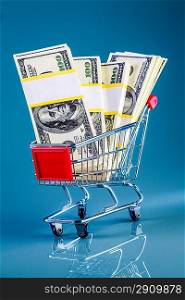 shopping cart and money on a blue background