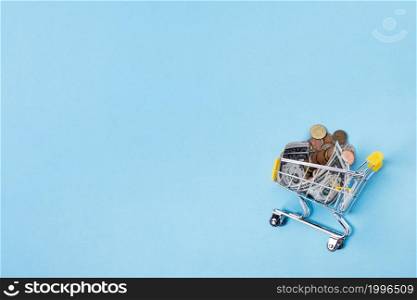 shopping cart filled with coins copy space background