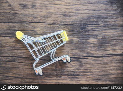 Shopping cart on rustic wooden background / Online shopping black Friday concept with yellow Shopping cart on top view - Shopping vacation