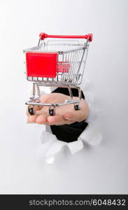 Shopping cart through hole in paper