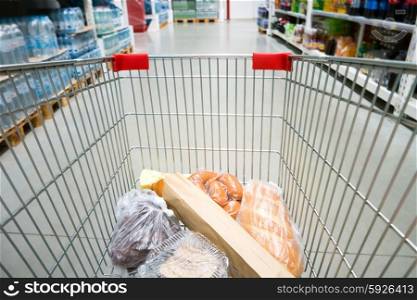 Shopping cart, trolley in a big supermarket with no people