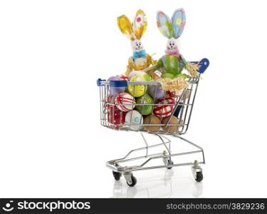 shopping cart with easter eggs and bunny couple isolated on white