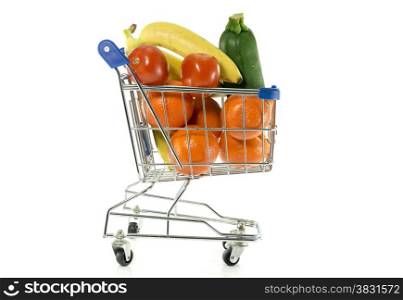 shopping cart with fresh fruit as bananas oranges and red tomatoand green gourgette