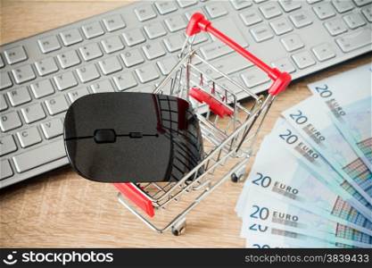 Shopping cart with mouse in front of computer keyboard ,online shopping concept