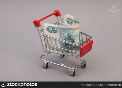 Shopping cart with Russian ruble on gray background