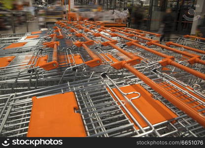 shopping carts in a store stand in a row