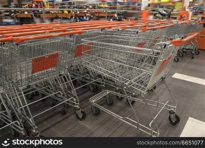 shopping carts in a store stand in a row
