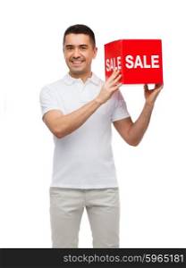 shopping, consumerism, discount and people concept - smiling man with red sale sigh