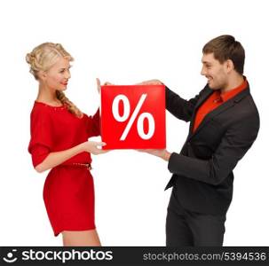 shopping, gifts, christmas, couple, x-mas concept - smiling woman and man with red percent sale sign