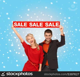 shopping, gifts, christmas, couple, x-mas concept - smiling woman and man with red sale sign