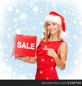 shopping, gifts, christmas, x-mas concept - smiling woman in santa helper hat with red sale sign