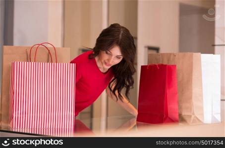 Shopping Girl Portrait. Beautiful Woman with Shopping Bags in Shopping Mall. Shopper. Sales. Shopping Center