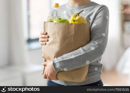 shopping, healthy eating and eco friendly concept - close up of woman with paper bag full of food. close up of woman with paper bag full of food