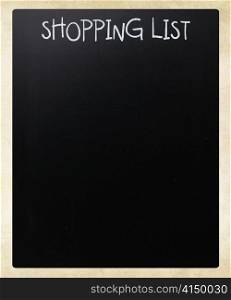 ""Shopping list" handwritten with white chalk on a blackboard"