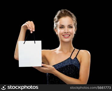 shopping, luxury, advertisement, holydays and sale concept - smiling woman with white blank shopping bag over black background