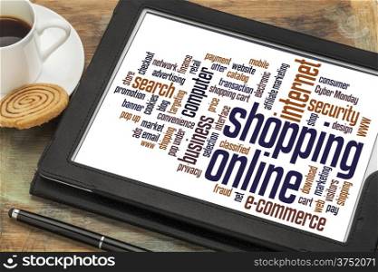 shopping online word cloud on a digital tablet with a cup of coffee