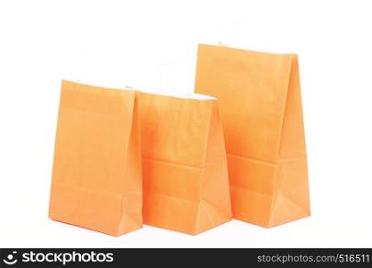 Shopping orange gift bags isolated on white background