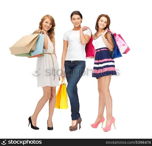 shopping, presents and gifts - attractive girls holding color shopping bags