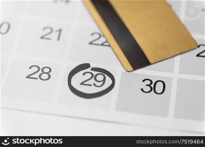 shopping, sale and marketing concept - close up of black friday date on calendar and credit card. black friday sale date on calendar and credit card