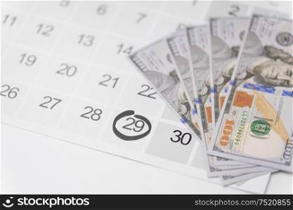 shopping, sale and marketing concept - close up of black friday date on calendar and money. black friday sale date on calendar and money