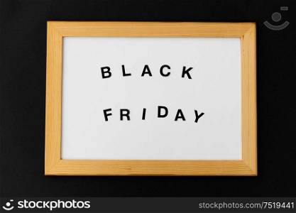 shopping, sale and outlet concept - white magnetic board with black friday words. magnetic board with black friday words